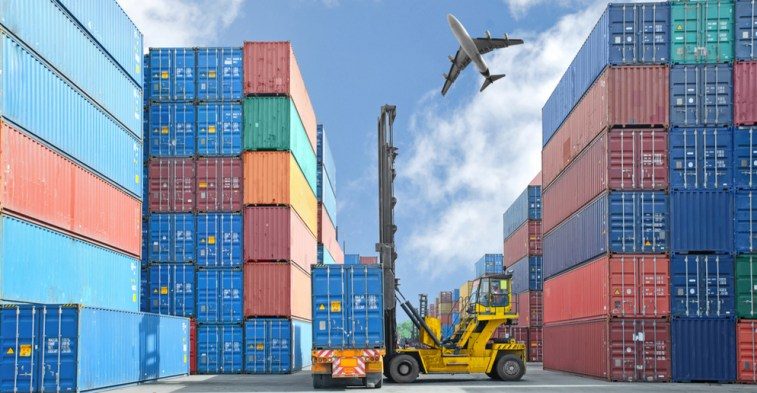 Container yard with cargo aircraft overhead